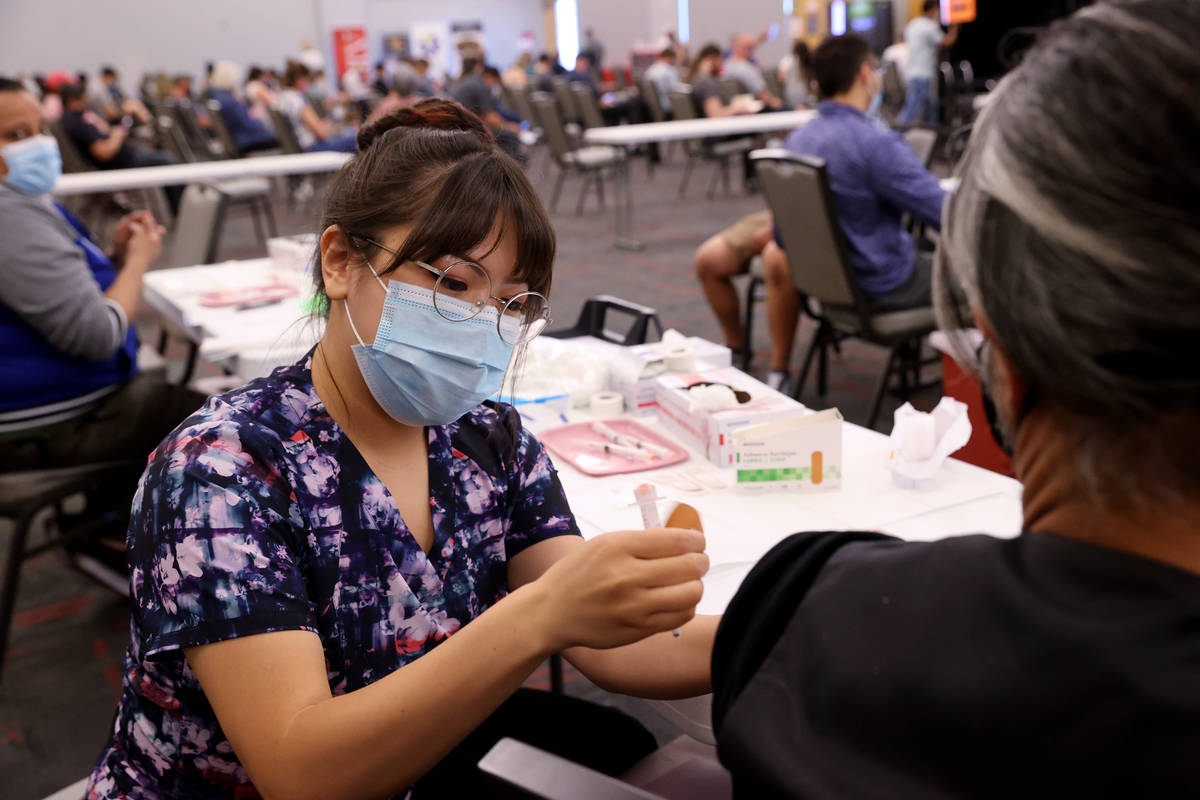 Deanna Chea of UNLV Medicine gives a COVID-19 shot at the UNLV vaccination site Monday, April 5 ...
