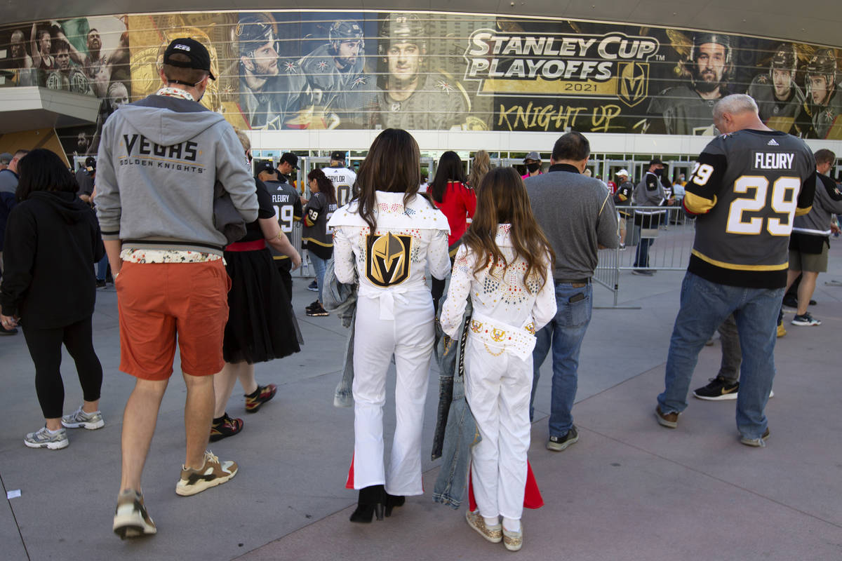 Two fans wear Elvis costumes before an NHL playoff game between the Golden Knights and the Wild ...