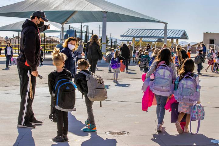 In this March 1, 2021, file photo, physical education teacher Mike Shenkberger, left, and other ...