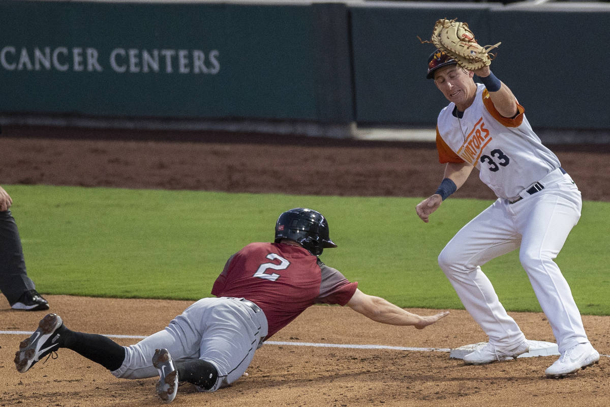 Las Vegas Aviators infielder Frank Schwindel (33) puts the tag on Sacramento River Cats infield ...