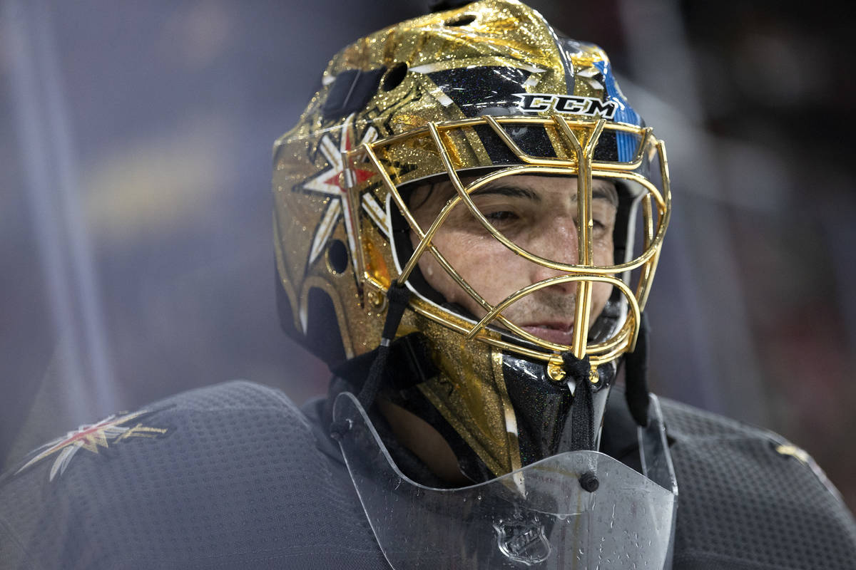 Golden Knights goaltender Marc-Andre Fleury (29) smiles while skating around the net after maki ...