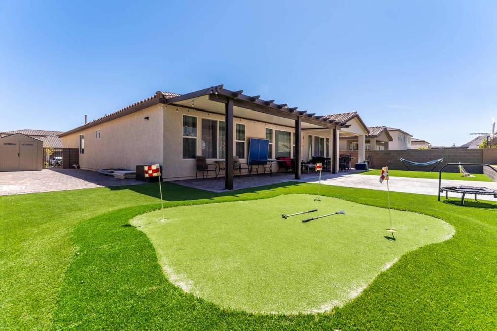 The rear exterior and putting green at 4601 Amazing View St. (SpotLight Home Tours)