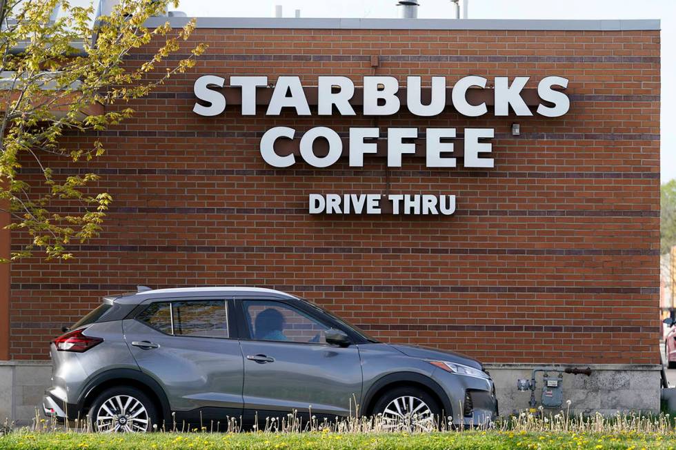 A customers exits the drive thru lane at a Starbucks coffee shop, Tuesday, April 27, 2021, in D ...