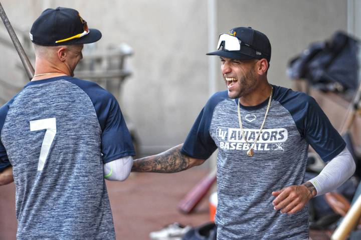 Aviators outfielder Luis Barrera, right, jokes around with teammate Greg Deichman during practi ...