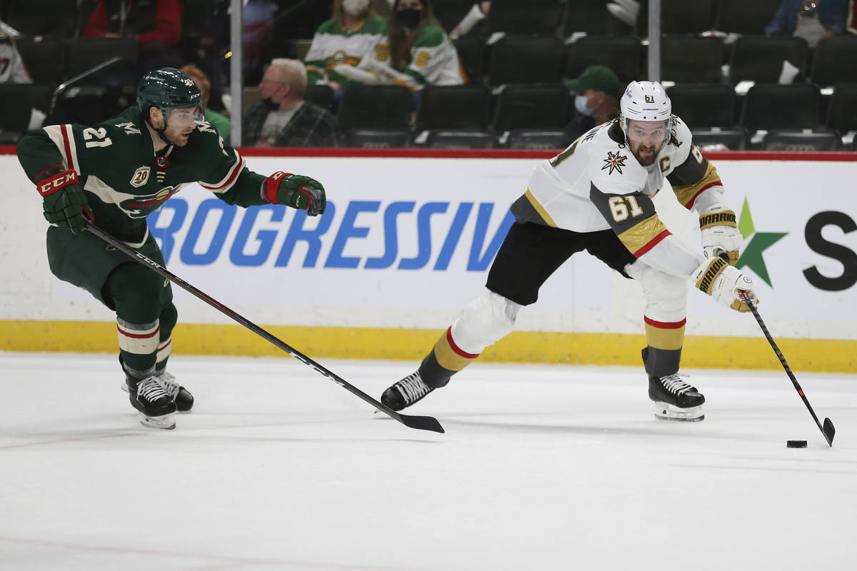 Vegas Golden Knights' Mark Stone (61) controls the puck next to Minnesota Wild's Carson Soucy ( ...