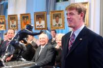FILE - USC quarterback Carson Palmer, right, smiles at the Heisman Trophy after being named the ...