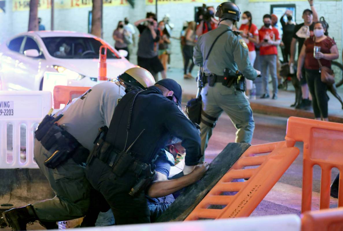 Las Vegas defense attorney Jonathan MacArthur is arrested during a demonstration in honor of Br ...