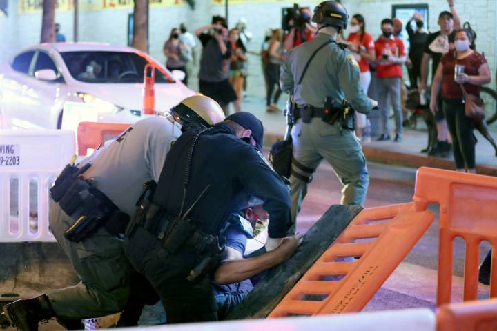 Las Vegas defense attorney Jonathan MacArthur is arrested during a demonstration in honor of Br ...