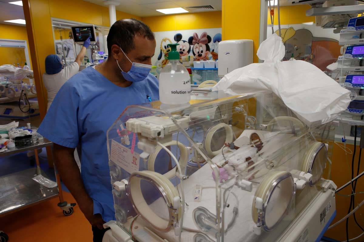 Paediatrician Dr. Msayif Khali watches one of the nine babies protected in an incubator at the ...
