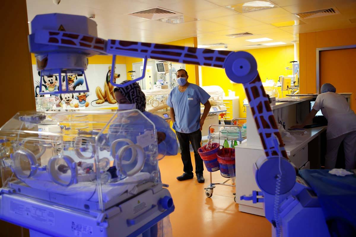 Paediatrician Dr. Msayif Khali supervises the operation as a nurse takes care of one of the nin ...