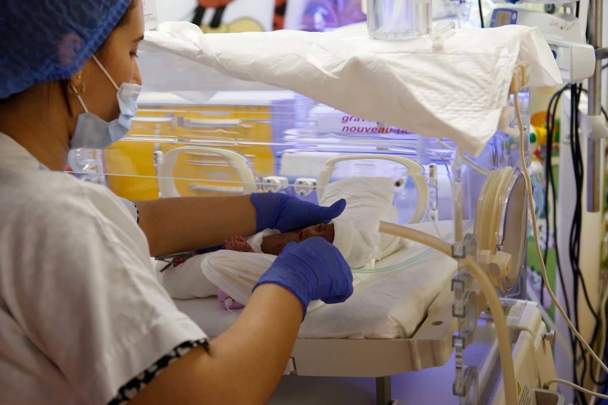 A Moroccan nurse takes care of one of the nine babies protected in an incubator at the maternit ...