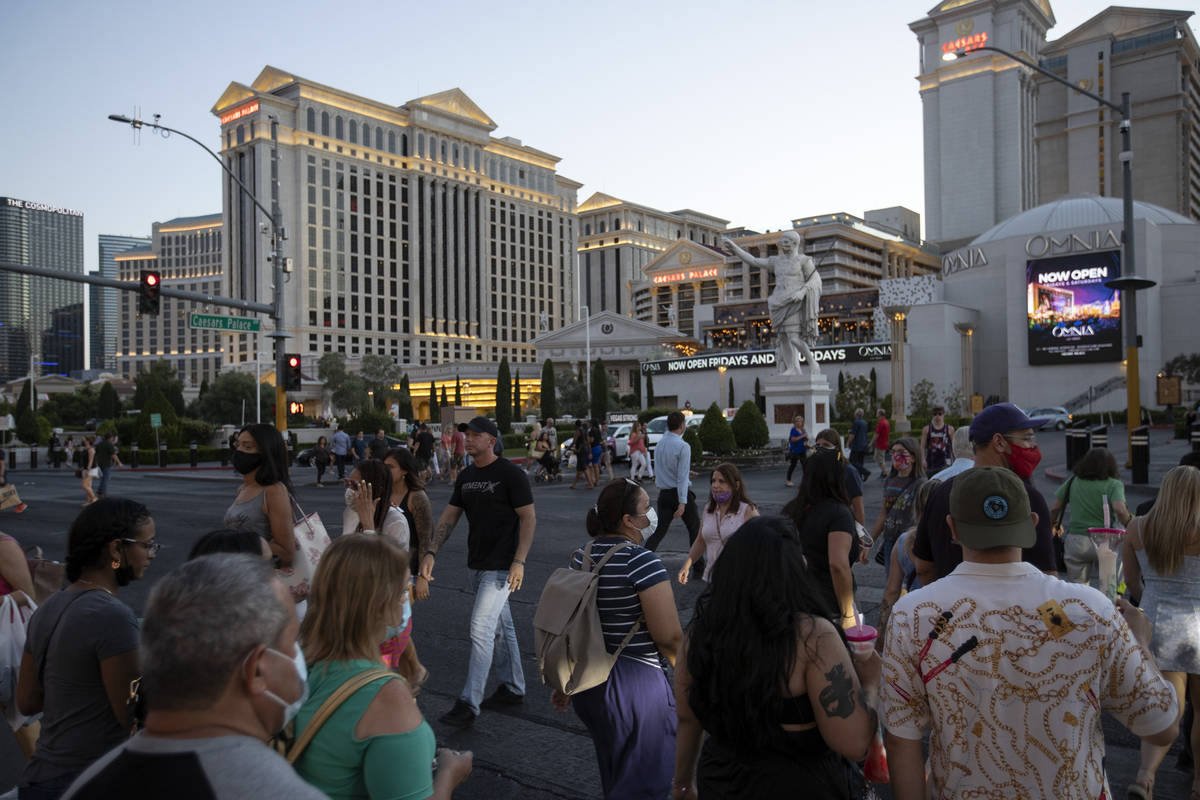 Some visitors to the Las Vegas Strip go mask-free outside Caesars Palace on Thursday, May 13, 2 ...