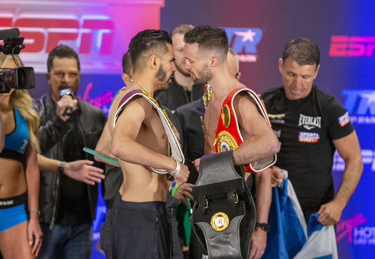 Jose Ramirez, left, and Josh Taylor stare each other down during a weigh-in event at the Virgin ...
