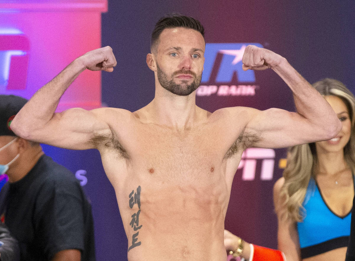 Josh Taylor poses on the scale during a weigh-in at the Virgin Hotel Las Vegas, Friday, May 21, ...