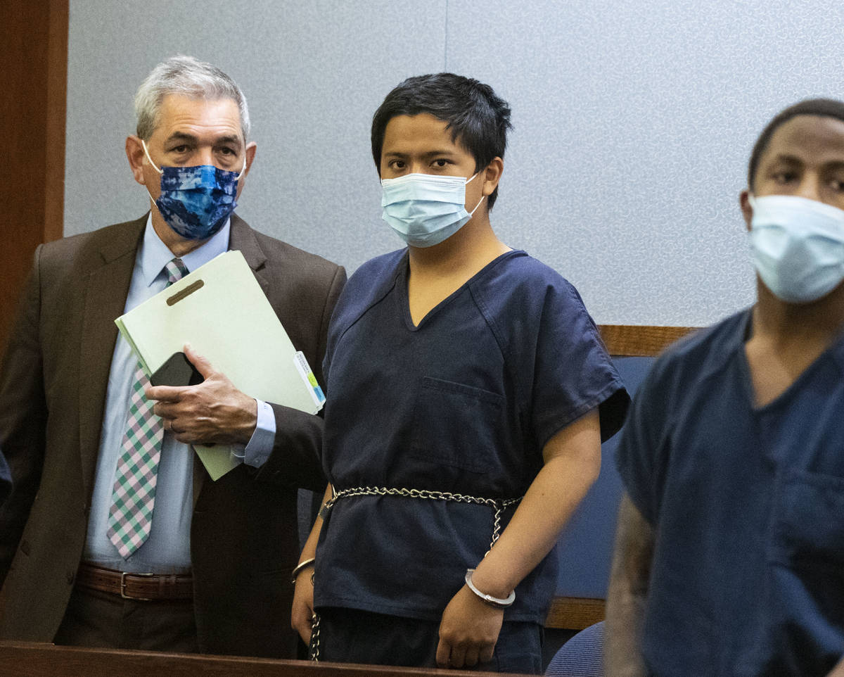 Aaron Guerrero, center, charged in the killing of Daniel Halseth, appears in court with his att ...