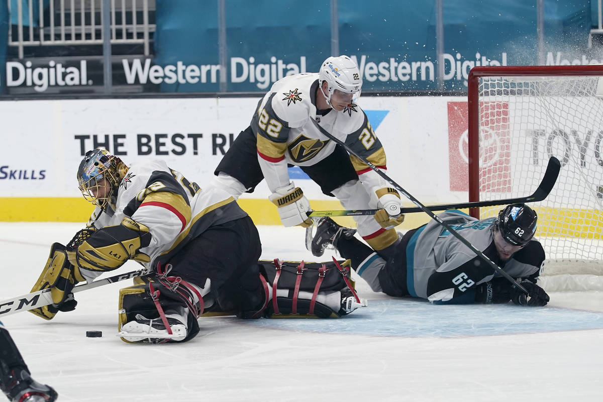 Vegas Golden Knights goaltender Marc-Andre Fleury, left, defends the goal in front of defensema ...