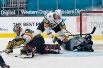 Vegas Golden Knights goaltender Marc-Andre Fleury, left, defends the goal in front of defensema ...