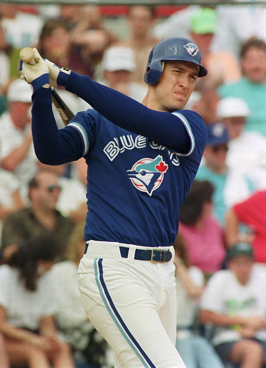 This March 21, 1992, photo shows Toronto Blue Jays first baseman John Olerud  swinging through a …