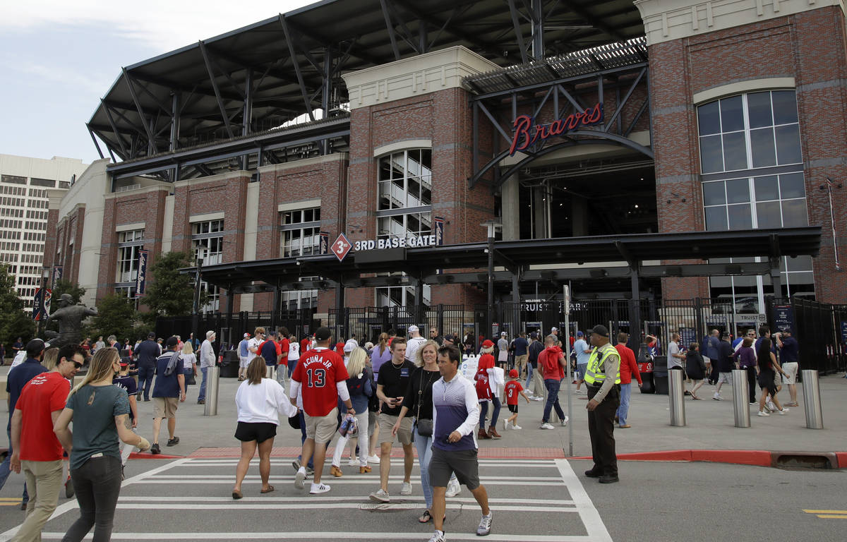 Fans make their way into Truist Park for the baseball game between the Atlanta Braves and the P ...