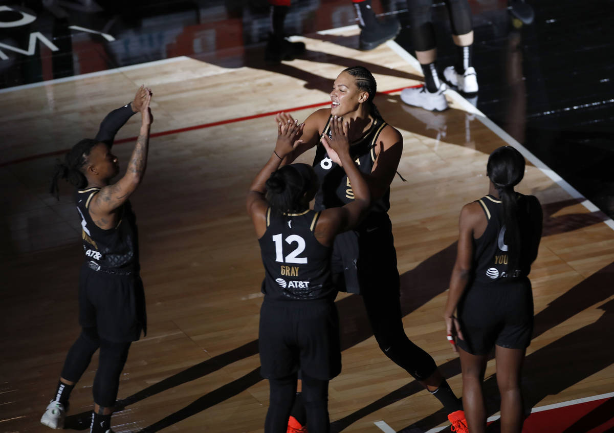Las Vegas Aces center Liz Cambage (8), center, is introduced before a WNBA basketball game agai ...