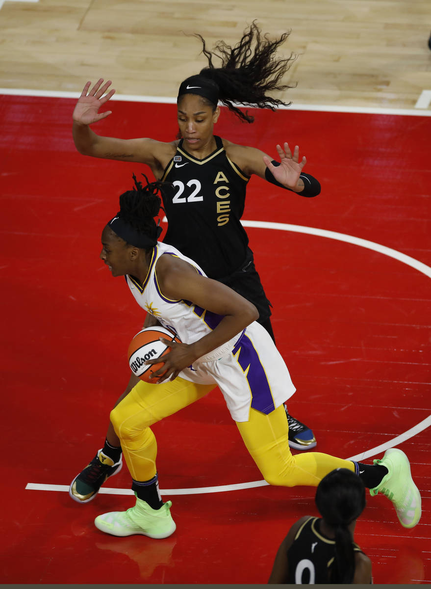 Los Angeles Sparks forward Nneka Ogwumike (30) tries to drive past Las Vegas Aces forward A'ja ...