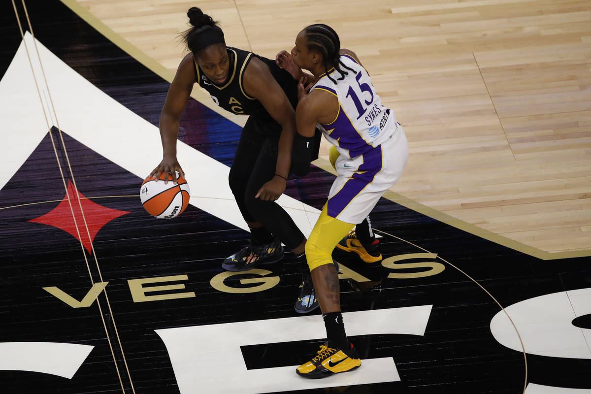 Las Vegas Aces guard Chelsea Gray (12) keeps a ball away from Los Angeles Sparks guard Brittney ...