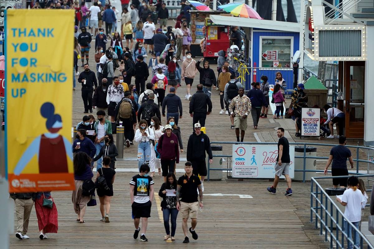 A posted sign thanks visitors for wearing masks in Santa Monica, Calif., on May 13, 2021. (AP P ...