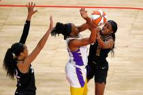 Las Vegas Aces guard Jackie Young (0), right and Los Angeles Sparks forward Nneka Ogwumike (30) ...