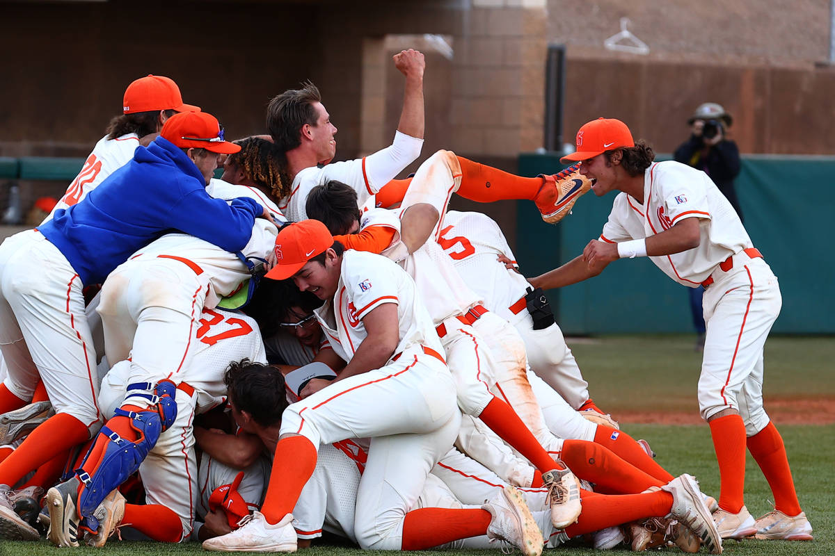 Bishop Gorman High School players celebrate their victory against Palo Verde in the Class 5A re ...