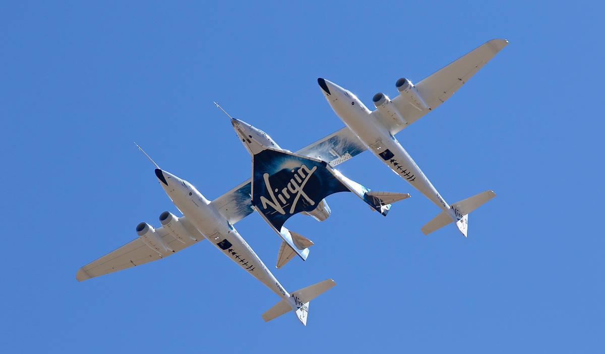 FILE - In this Thursday, Feb. 13, 2020 file photo, Virgin Galactic's VSS Unity departs Mojave A ...