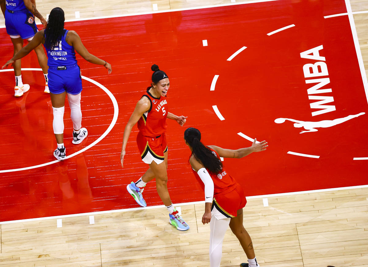 Las Vegas Aces' Dearica Hamby (5) celebrates with A'ja Wilson (22) after scoring against Connec ...