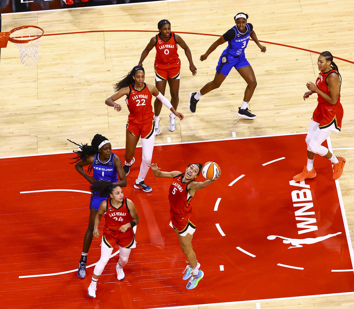 Las Vegas Aces' Dearica Hamby (5) reaches out for a rebound in front of Connecticut Sun's Beatr ...