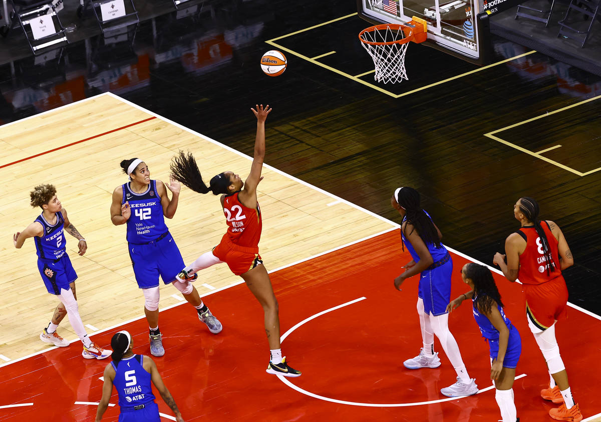 Las Vegas Aces' A'ja Wilson (22) shoots in front of Connecticut Sun's Brionna Jones (42) during ...