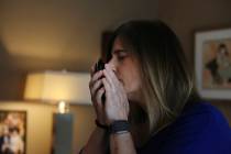 Michelle Pepe tries to smell her late father's wallet while going through his belongings one ye ...