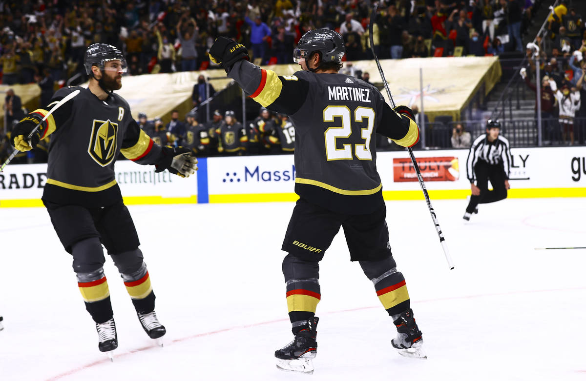 Golden Knights' Alec Martinez (23) celebrates his goal with Alex Pietrangelo (7) during the sec ...