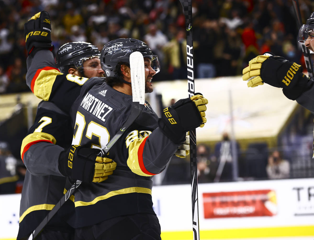 Golden Knights' Alec Martinez (23) celebrates his goal with teammates during the second period ...