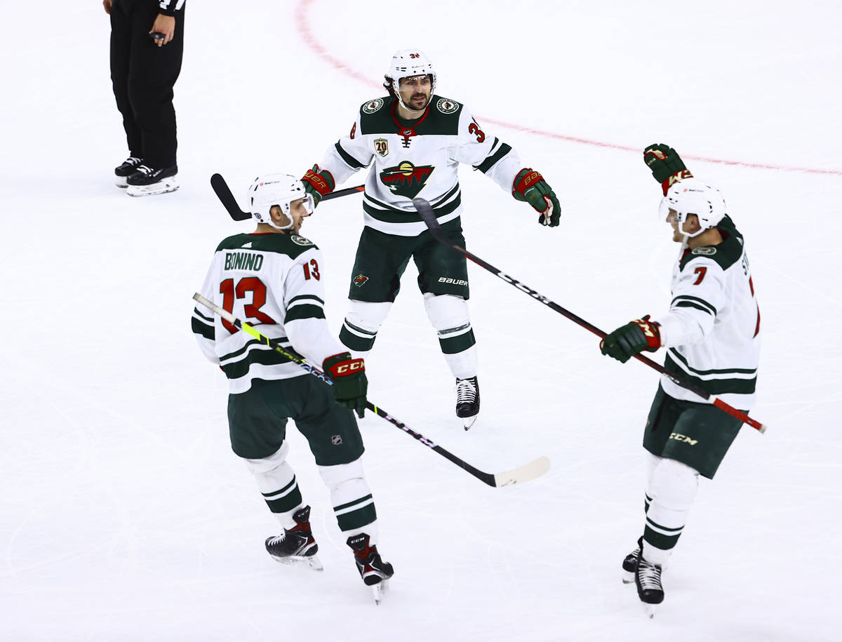 The Minnesota Wild celebrate an empty net goal against the Golden Knights during the third peri ...