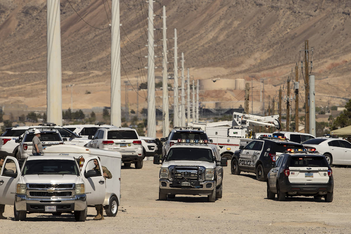 Metro officers and military personnel are near the scene of a Nellis Air Force Base jet crash o ...