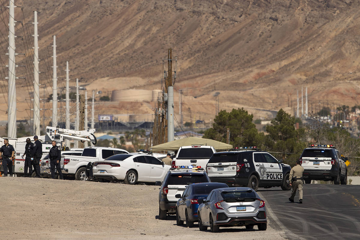 Metro officers and military personnel are near the scene of a Nellis Air Force Base jet crash o ...