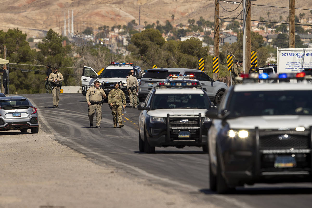 Metro officers and military personnel are move about as they stage for a Nellis Air Force Base ...