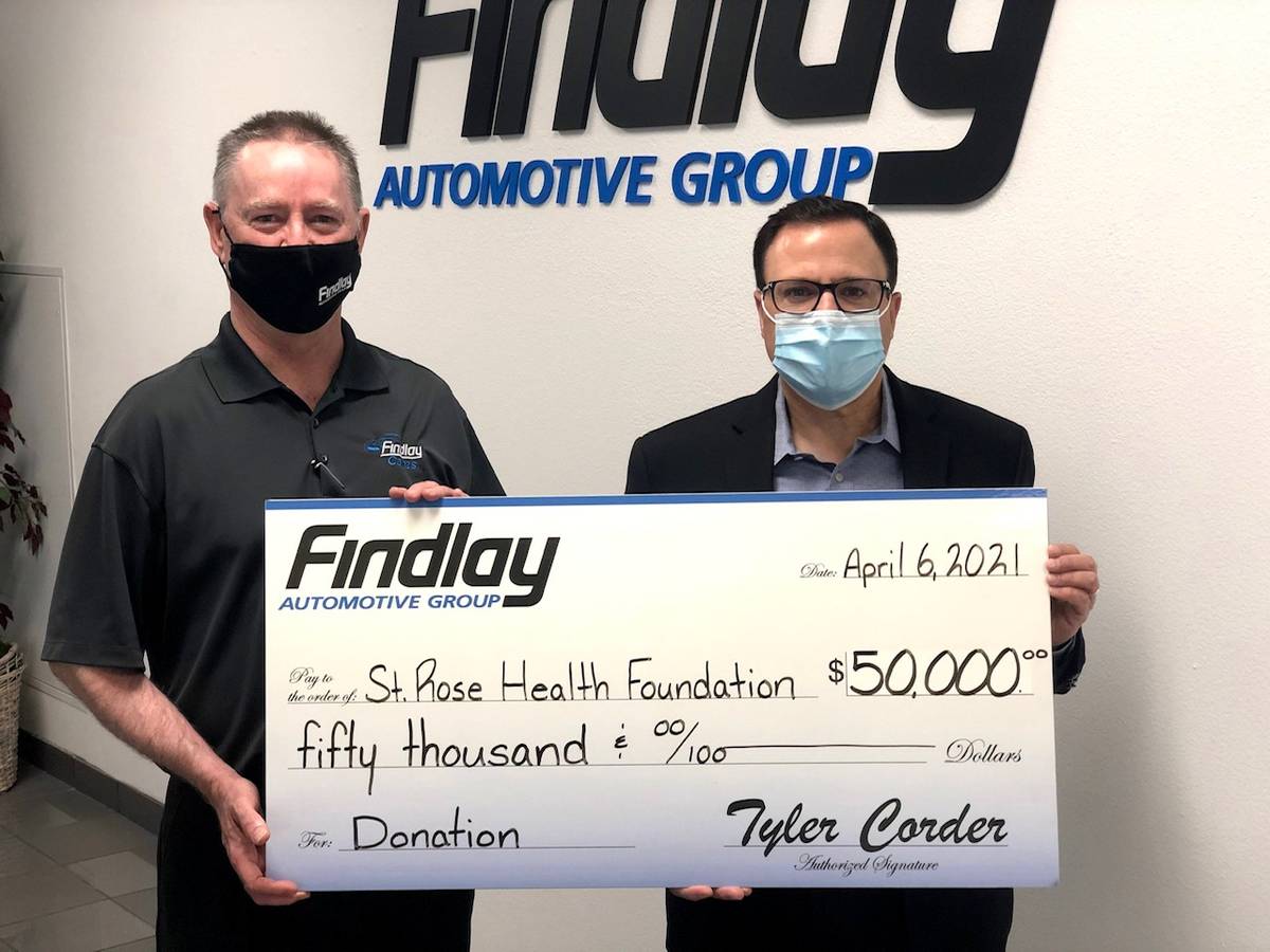 Findlay Automotive Group CFO Tyler Corder, left, makes a $50,000 donation to St. Rose Dominican ...