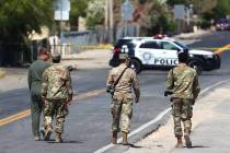 Military personnel investigate an airplane crash near Nellis Air Force Base, on Tuesday, May 25 ...