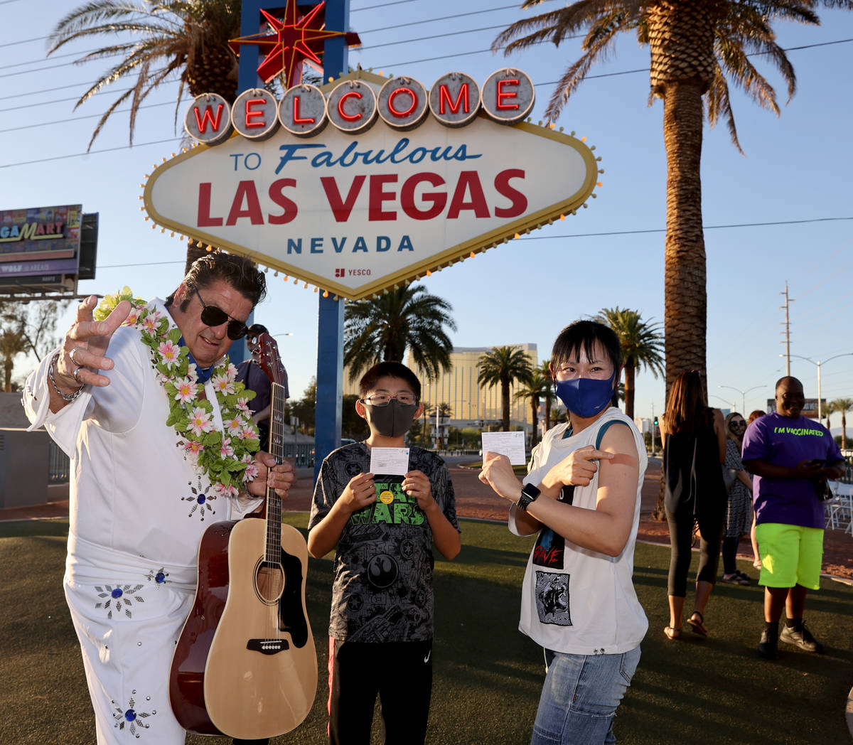 Elvis impersonator Mark Edward Rumpler poses with Izumi Kimoto, 44, and her on Joe, 12,&#x ...
