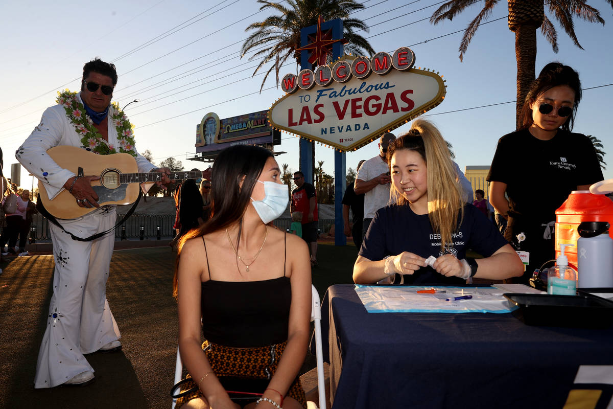 Touro University Physician Assistant student Debbie Min gives a COVID-19 vaccine to Valeria Mor ...