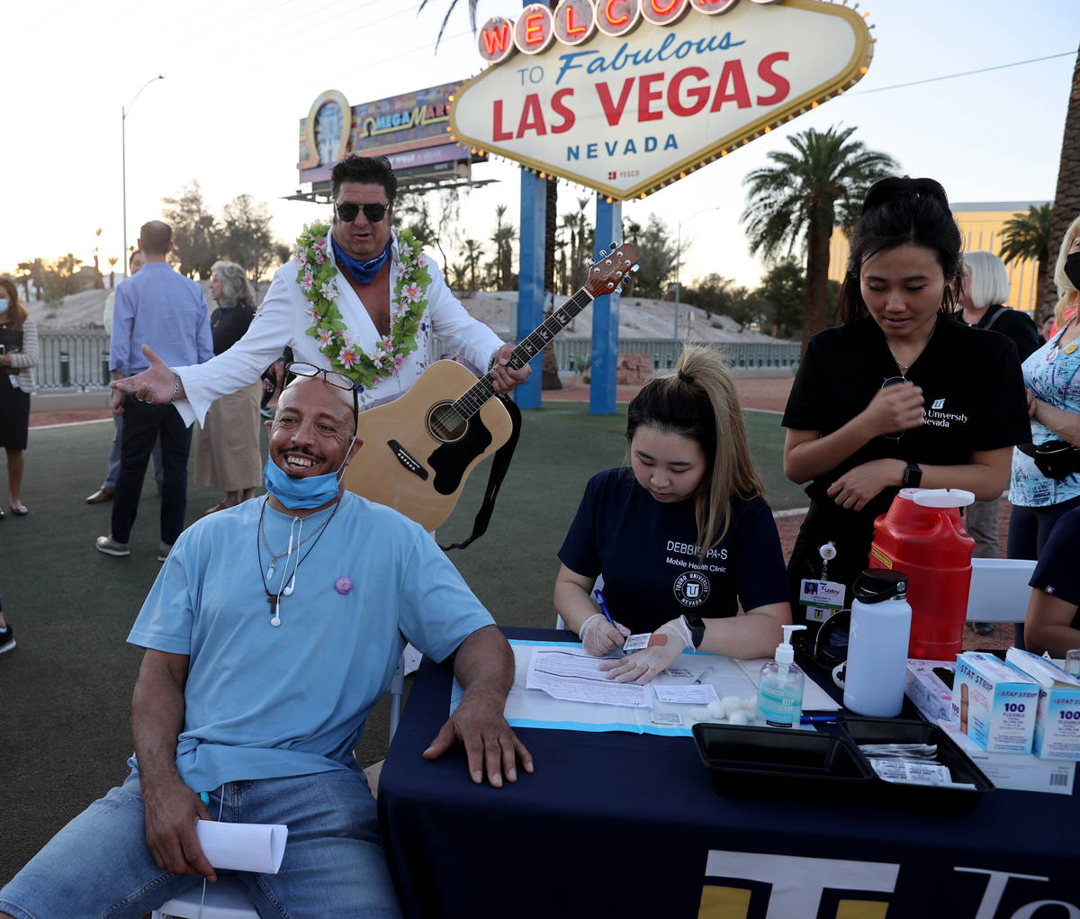 Touro University Physician Assistant student Debbie Min prepares to give a COVID-19 vaccine to ...