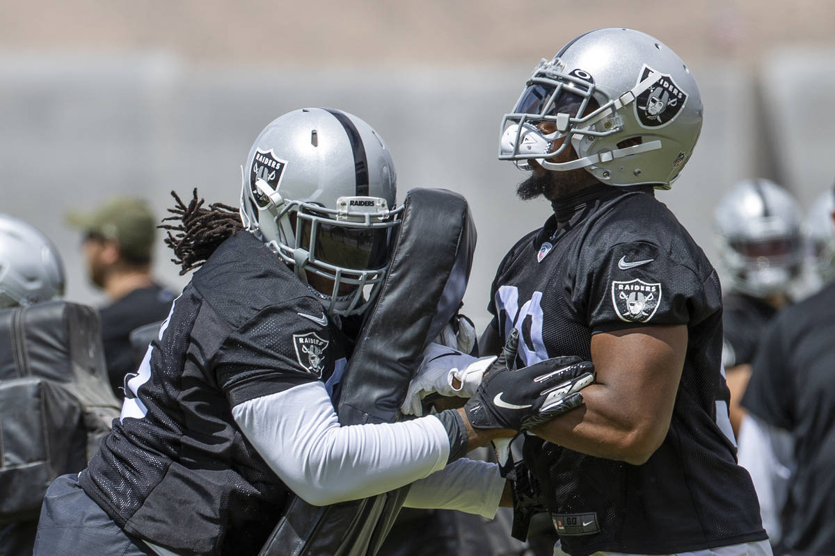 Defensive lineman Darius Philon (96, left) runs a drill with defensive end Clelin Ferrell (99) ...