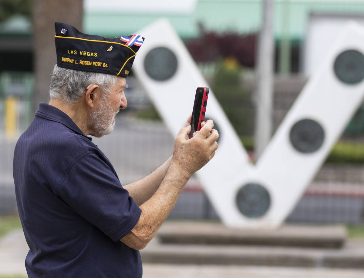 Morton Friedlander, a 88-year-old veteran of the Korean War, and Vietnam, takes a picture of th ...
