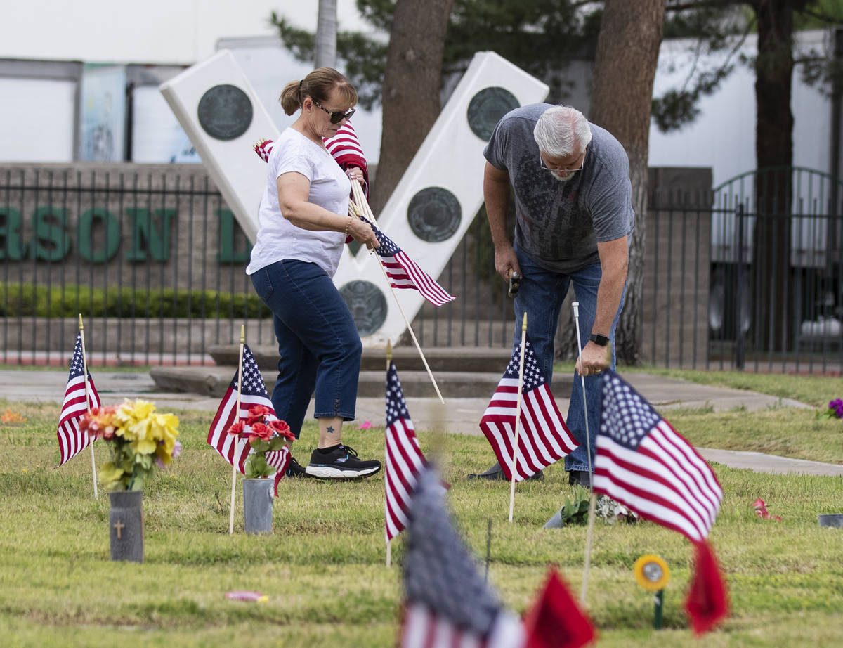 Lori Bordman, left, and her husband Garry, both retired United States Air Force, place American ...