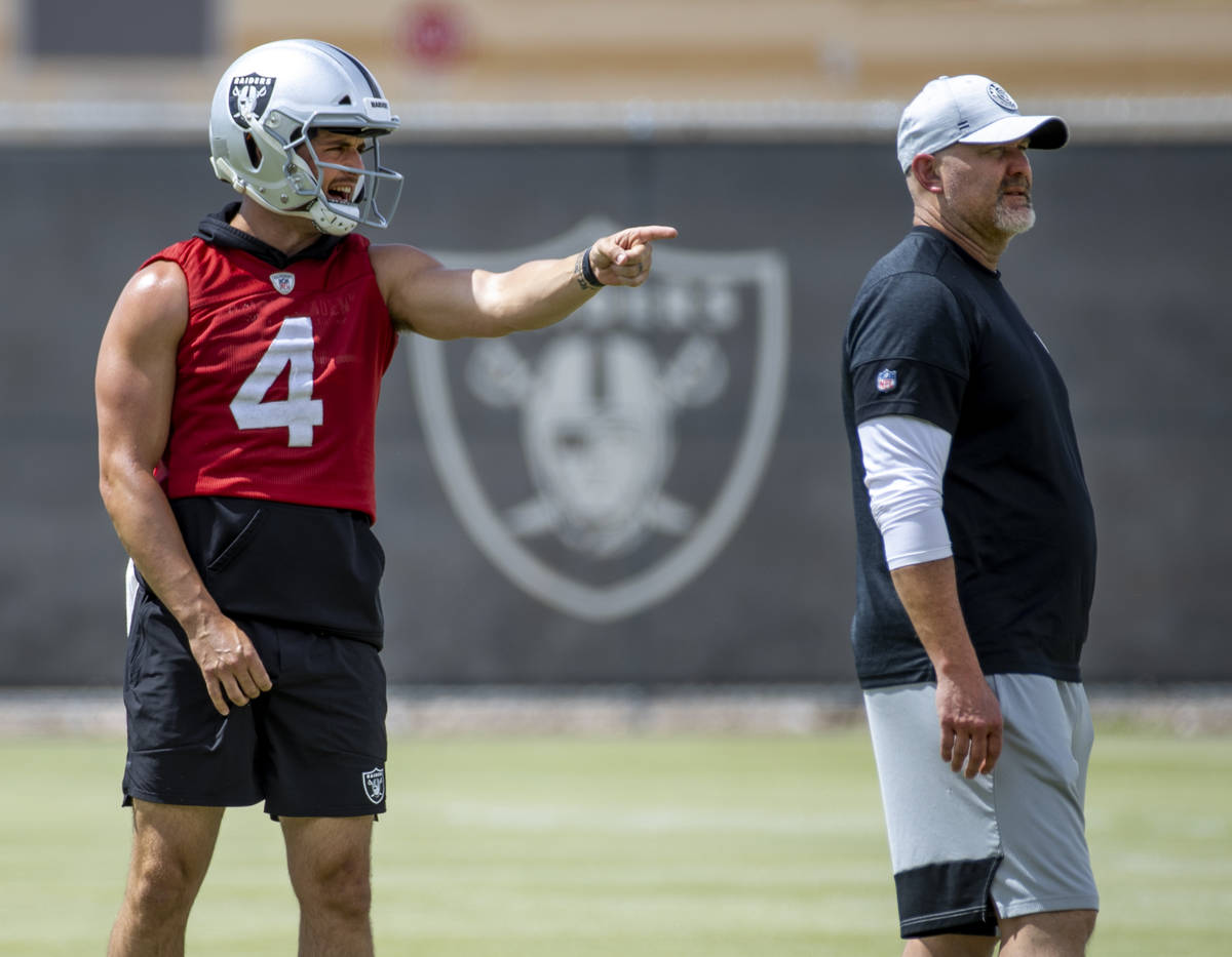 Quarterback Derek Carr (4) yells to a teammate as Senior Offensive Assistant John Morton looks ...