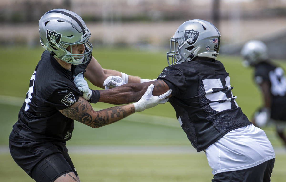 Defensive end Maxx Crosby (98, left) and defensive end Gerri Green (52) run a drill during a La ...
